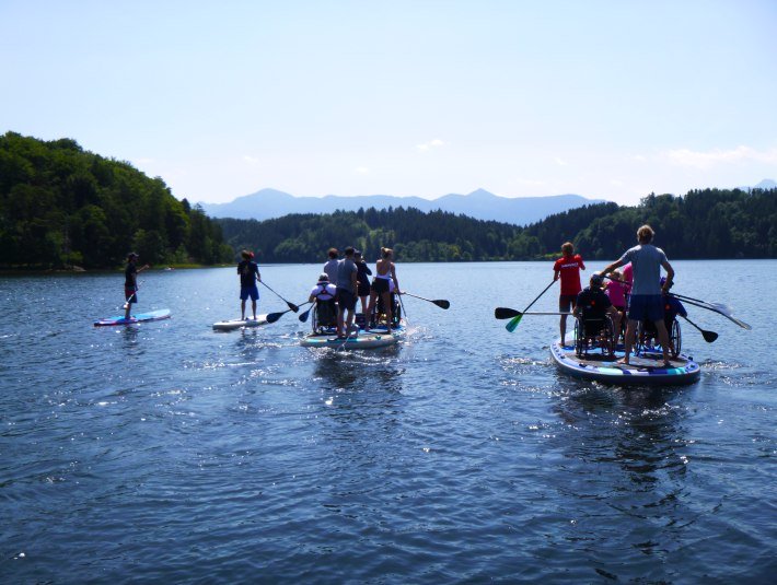 Menschen mit Rollstuhl auf einem SUP auf dem See, &copy; SUP Verleih Staffelsee